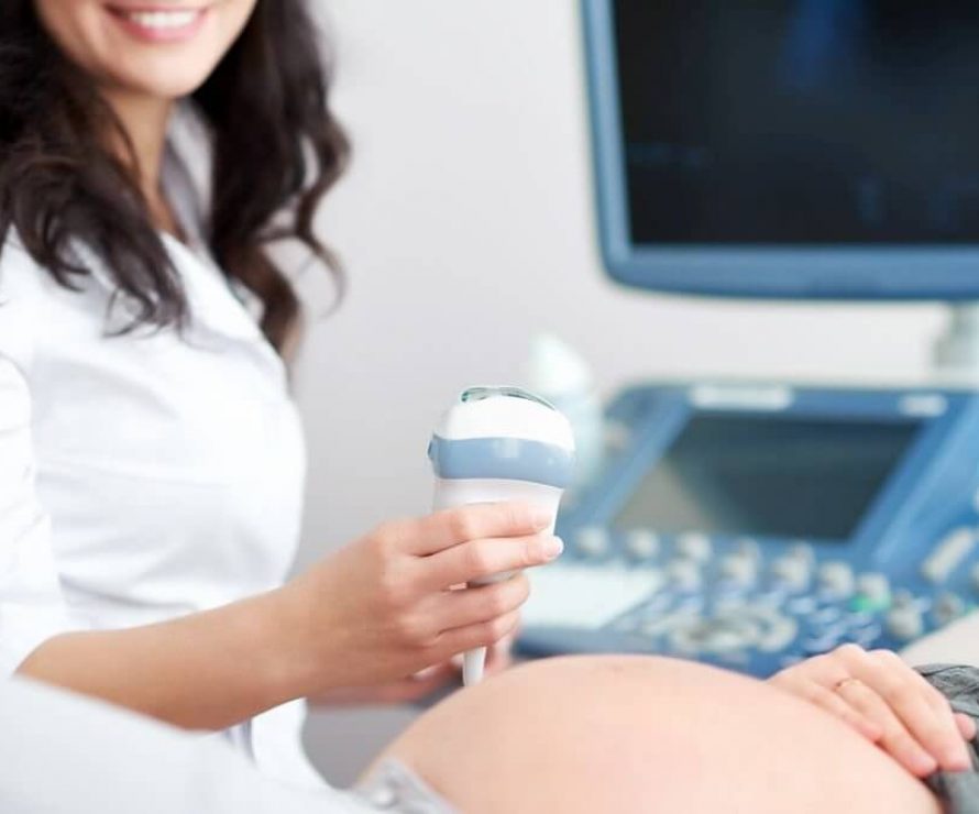 Cropped shot of a cheerful smiling female doctor performing ultrasound scanning working with her pregnant patient at the clinic copyspace equipment modern technology research pregnancy health.